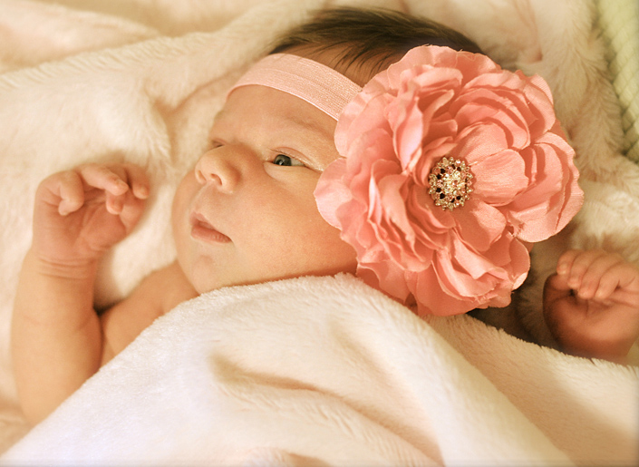 Newborn Leah models her flower headband