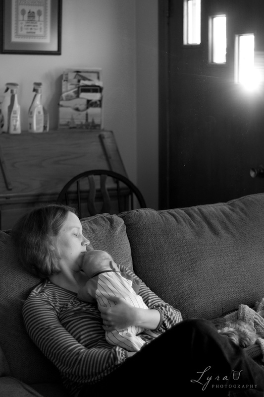 Newborn resting with mom on couch at home
