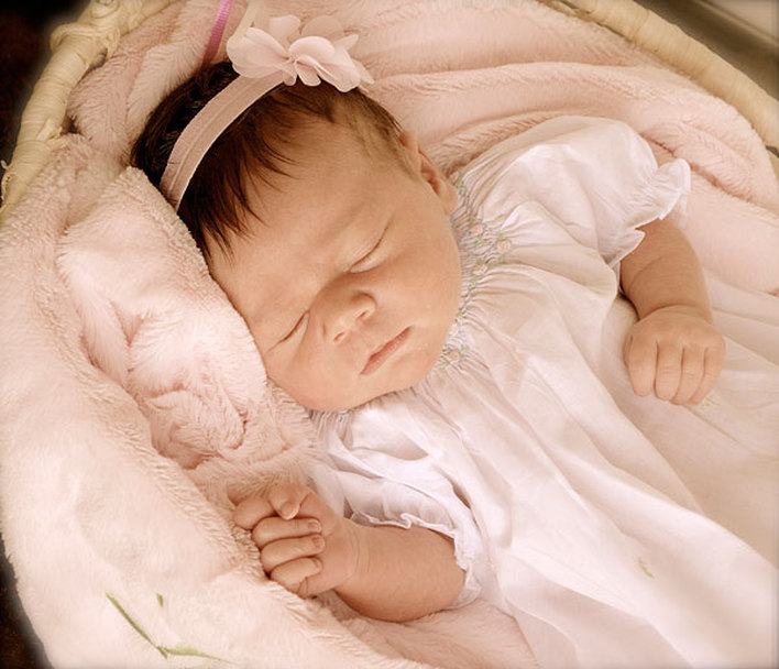 Sweet newborn Leah asleep in a basket