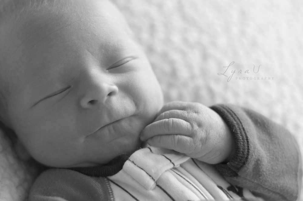 Newborn face and fingers black and white