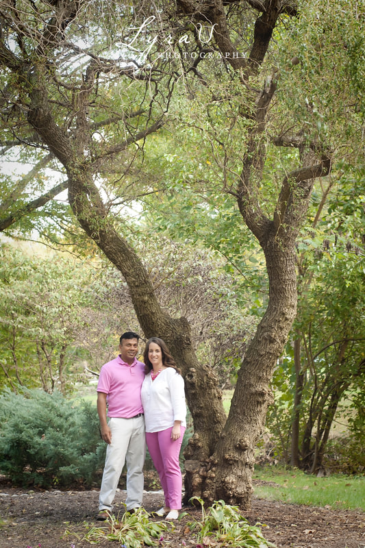 Couple standing under a willow tree